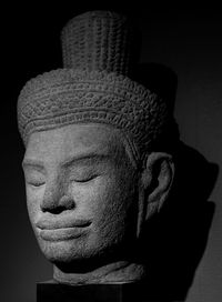 Close-up of statue against black background
