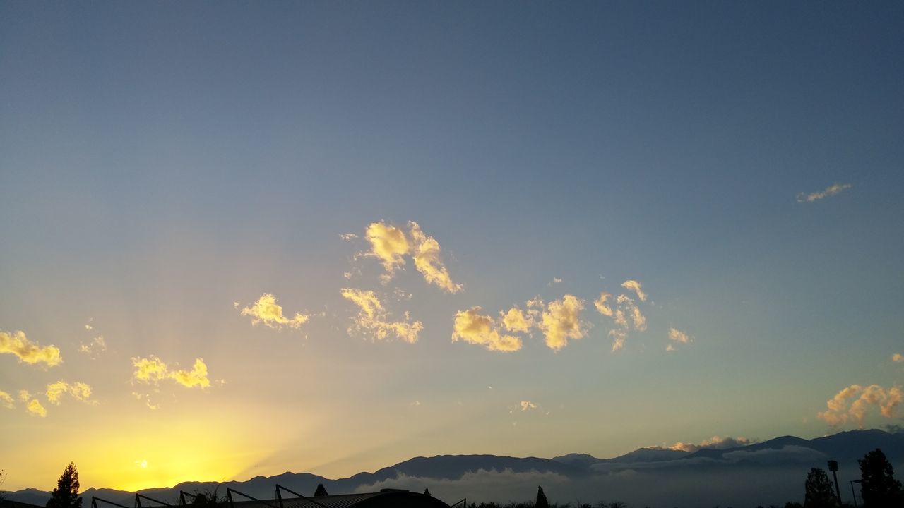 mountain, sky, beauty in nature, sunset, scenics, silhouette, tranquil scene, landscape, tranquility, nature, copy space, mountain range, cloud - sky, idyllic, sunlight, outdoors, blue, cloud, low angle view