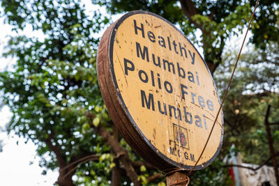 Close-up of information sign against trees