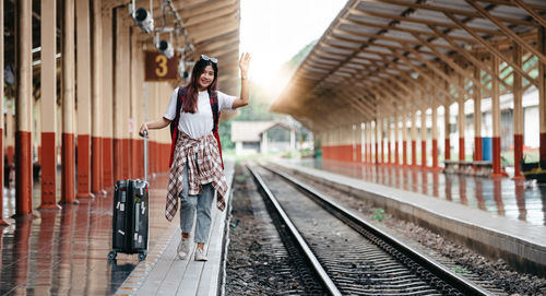 Woman standing on railroad station platform