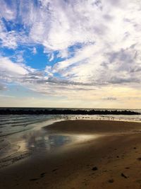 Scenic view of beach against blue sky