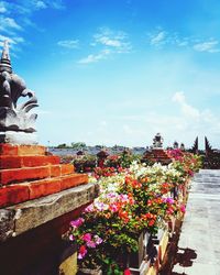 Statue of flowers against cloudy sky