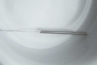 High angle view of acupuncture needle in bowl