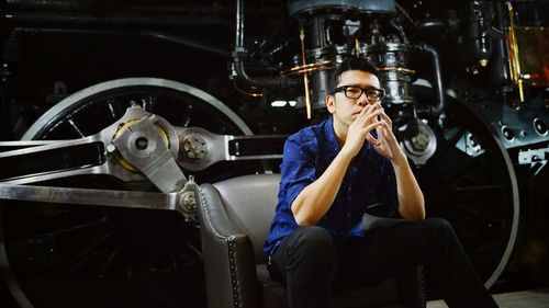 Portrait of man sitting by train