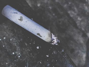 High angle view of cigarette smoking on floor