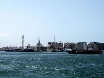 View of buildings in city against clear sky