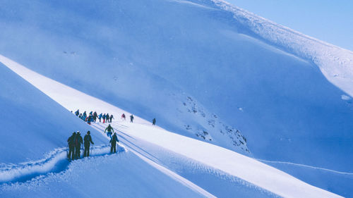People skiing on snowcapped mountains