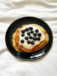 High angle view of food in plate on bed