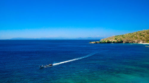 Scenic view of sea against clear blue sky