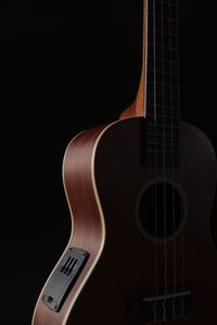 Close-up of guitar against black background