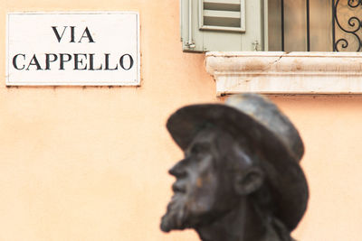 Berto barbarani statue against placard on wall