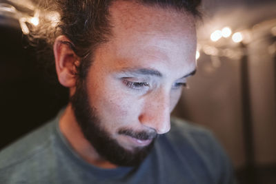 Close-up portrait of young man looking away