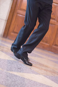 Low section of man wearing shoes on floor