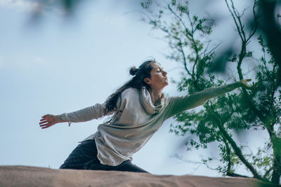 Woman dancing in forest