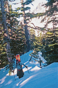 Full length of man skiing on snow covered land