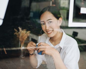 Portrait of young woman sitting outdoors