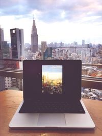 City skyline against cloudy sky