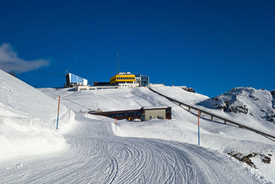 Snow covered mountain against blue sky