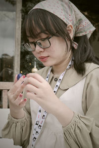 Portrait of young woman using mobile phone