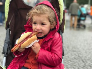 Close-up of girl eating hot dog