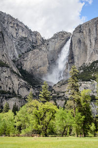 Scenic view of waterfall against sky