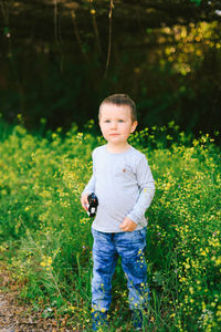 Portrait of cute boy standing on land
