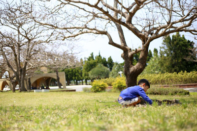 Boy playing on grassy field