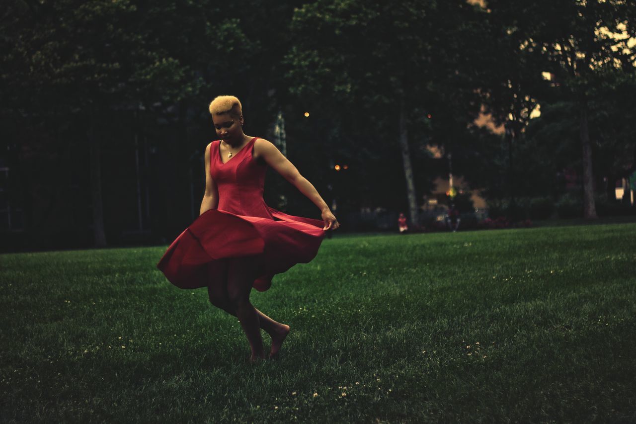 full length, grass, lifestyles, leisure activity, young adult, casual clothing, field, side view, person, standing, young women, grassy, tree, park - man made space, front view, night, dress, green color