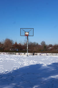 View of basketball hoop on field against sky