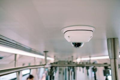 Low angle view of surveillance camera on ceiling