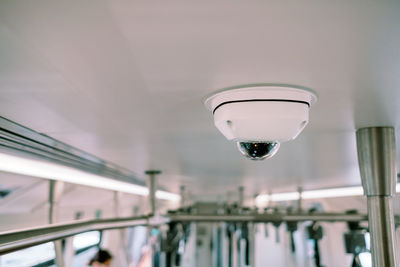 Low angle view of surveillance camera on ceiling