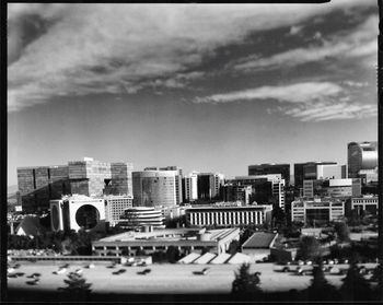 Tilt-shift image of cityscape against sky