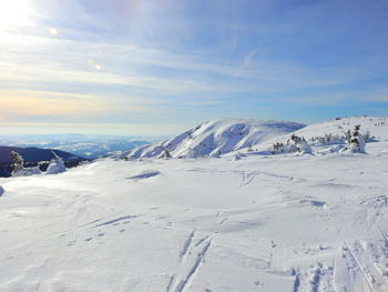 Scenic view of snow covered mountains against sky