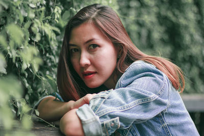 Portrait of beautiful woman by plants