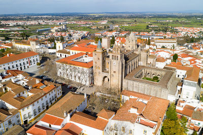 Evora drone aerial view on a sunny day with historic buildings city center in alentejo, portugal