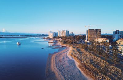 Panoramic view of sea and buildings against clear blue sky