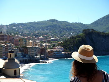 Rear view of woman looking at sea against sky