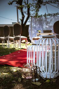 Empty chairs and tables in yard