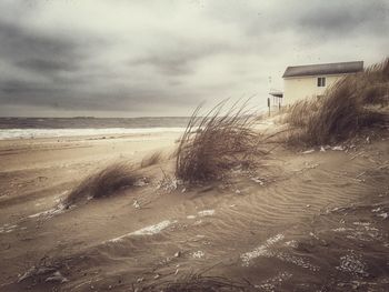 View of beach against cloudy sky