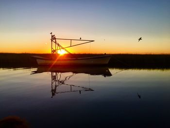 Scenic view of calm lake against romantic sky at sunset