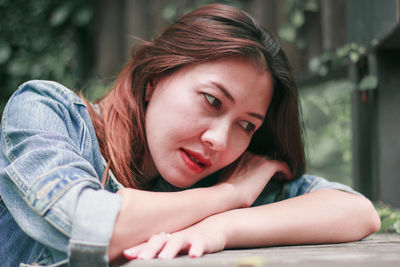 Portrait of smiling woman sitting outdoors