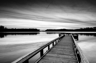 A wood fishing pier at sunset on worster lake, potato creek state park, north liberty, indiana.