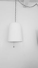 Close-up of electric lamp against white wall