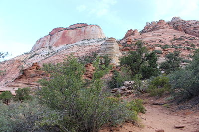 Rock formations on landscape against sky