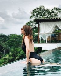 Full length of young woman in swimming pool