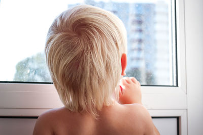 Happy child in home quarantine playing and laughing at the window. stay home concept.