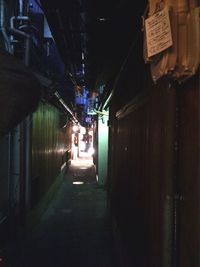 Illuminated tunnel at night