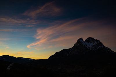 Scenic view of silhouette mountains against sky during sunset