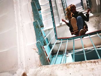 High angle view of women sitting on railing