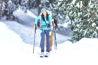 Man skiing on snow covered landscape